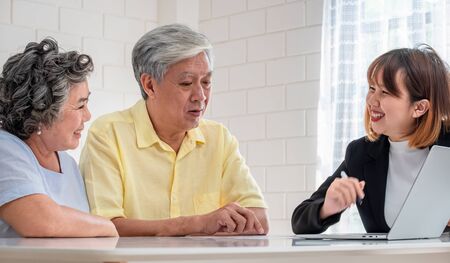 Senior couple get advice from financial planner at home.aging at homeの写真素材