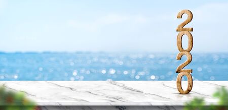 new year 2020 on marble table top with blur blue sky and sea boekh background,summer holiday backdrop.Mock up template for display or montage of product or content use as panoramic bannerの写真素材