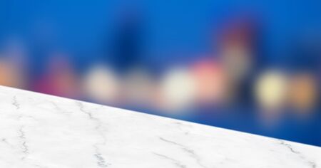 Empty white angle marble table top with blur city bokeh abstract background,panoramic banner for display or montage of productの写真素材