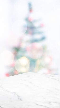 Empty white marble table top with abstract Christmas tree decor string light blur background,Holiday backdrop,Mockup vertical banner for display of product and advertise on online media.ratio16:9の写真素材