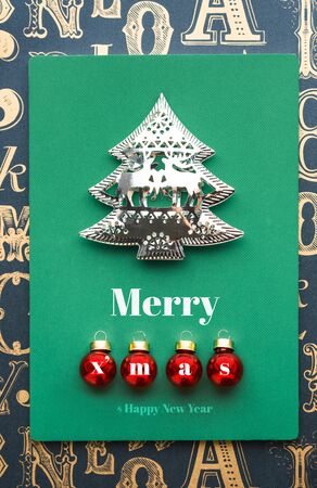 Merry Christmas and tree and xmas red ball decoration with green notebook on old type pattern background.holiday greeting cardの写真素材