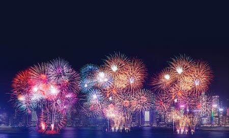 Happy new year  firework over cityscape building near sea at night time celebration,mock up Banner for advertise on social mediaの写真素材