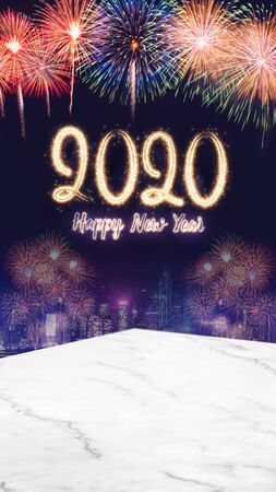 Happy new year 2020 fireworks over cityscape at night with empty marble table top,vertical banner mock up template for display or montage of product for holiday advertiseの写真素材