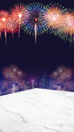 Happy new year 2020 fireworks over cityscape at night with empty marble table top,vertical banner mock up template for display or montage of product for holiday advertiseの写真素材