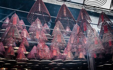 looking up at incense coil at chinese templeの写真素材