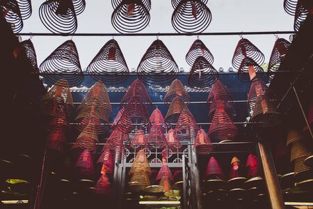 looking up at incense coil at chinese templeの写真素材