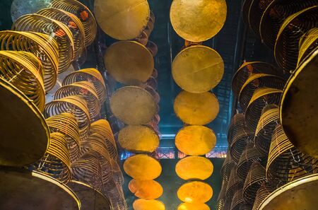 looking up at incense coil at chinese templeの写真素材