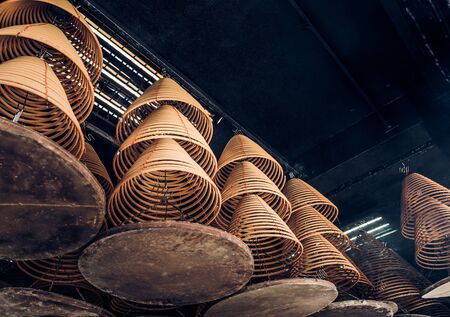 looking up at incense coil at chinese templeの写真素材