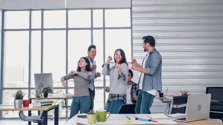 group of creative designer dancing in office with relax feeling and glad about good success news of project at modern office.business day work lifestyleの写真素材