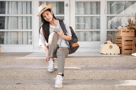 young traveler wearing shoe infront of house before go travelの写真素材