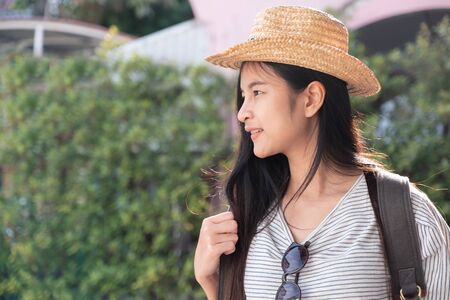 Asian woman traveler backpacker looking for route of place on street in when travel in city,journey tripの写真素材