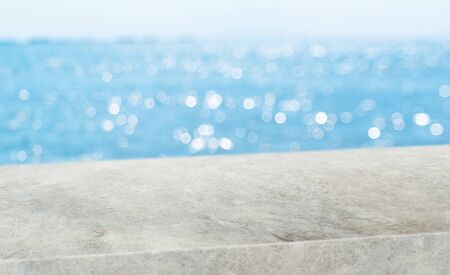 summer background.Empty diagonal grunge concrete table with blur sea and sky boekh background,banner mockup template for display of productの写真素材