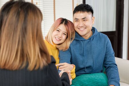 Asian happy couple getting key and handshake with realtor agent with smiling face at new home.buying new house real estateの写真素材