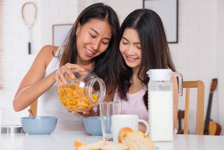 Happy asian lesbian woman couple have breakfast at house in morning with love and tender.LGBTQ lifestyle conceptの写真素材