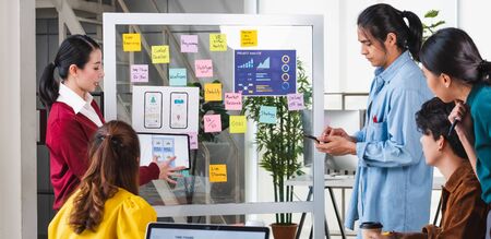 ux developer and ui designer presenting  and testing mobile app interface design on whiteboard in meeting at modern office.Creative digital development mobile app agencyの写真素材
