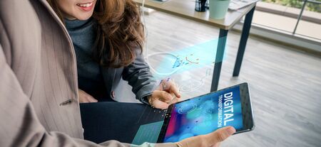 digital transformation concept,asian business woman learning from tablet about digitization transform analog to digital in business.の写真素材