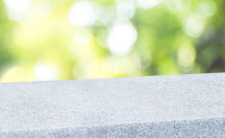 spring background.Empty diagonal pebble stone table with blur tree in garden boekh background,banner mockup template for display of productの写真素材