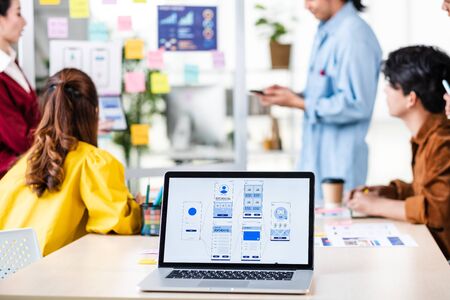 ux developer and ui designer presenting  and testing mobile app interface design on whiteboard in meeting at modern office.Creative digital development mobile app agencyの写真素材