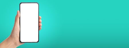 mockup hand touch on mobile blank screen on green background in banner size for display  content to advertise on online media.technology background.  on both hand and phone screenの写真素材