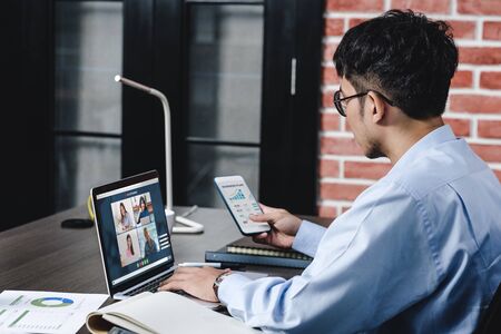 Work from home with asian businessman video conference collaboration with colleagues.live streaming meetingの写真素材