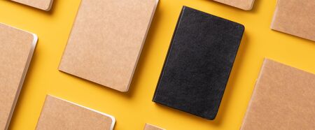 creativity content marketing concept,.top view of notebook align in pattern on yellow table background.mockup for advertise content online.unique ideaの写真素材