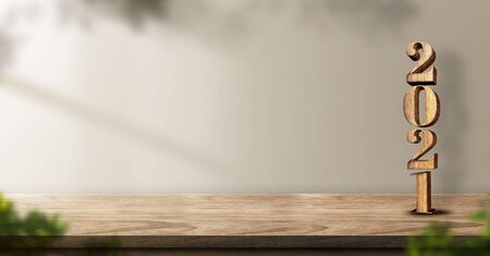 2021 happy new year wood on wood table background with sunlight and plantの写真素材
