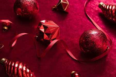 red christmas decoration bauble and ribbon on velvet red felt fabric  top view table backgorundの写真素材