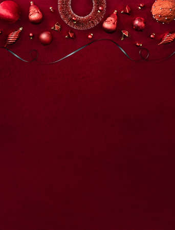 red christmas decoration bauble and ribbon on velvet red felt fabric  top view table backgorundの写真素材