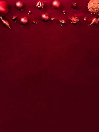 red christmas decoration bauble and ribbon on velvet red felt fabric  top view table backgorund.vertical layoutの写真素材