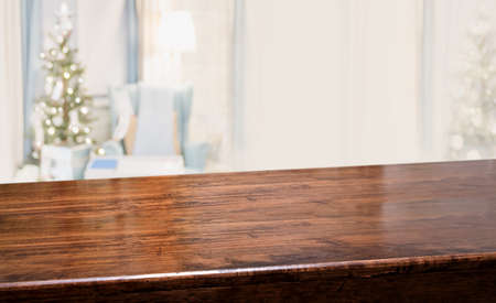 Perspective wood table with blur Christmas tree decorate string light in living room at home.Panoramic wooden countertop banner mockup for product display greeting card design online contentの写真素材