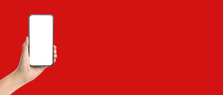 mockup hand holding mobile blank screen on red background.mockup banner display of content to advert on media.  both hand and smartphone screenの写真素材