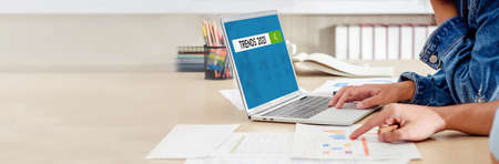close up hand creative designer team meeting and brainstorming trends 2021 with paperwork and online...