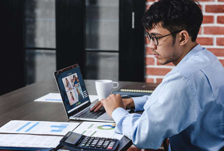 Work from home with asian businessman video conference collaboration with colleagues.live streaming meetingの写真素材