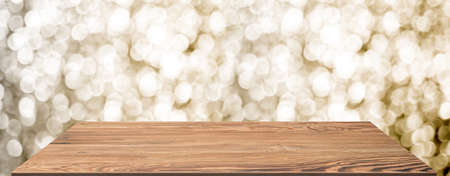 wooden table at blur abstract gold bokeh background,Mockup banner space for display or montage of product,holiday celebration greeting cardの写真素材