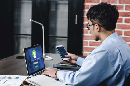 asian businessman asking chatbot on laptop while working on desk  at office.digital workflow online business lifestyle conceptの写真素材
