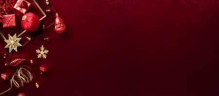 red christmas decoration bauble and ribbon on velvet red felt fabric  top view table backgroundの写真素材