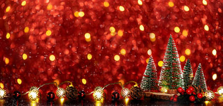 Merry Christmas tree and happy new year background on red glitter sparkling string lights festive bokeh background.holiday celebration greeting cardの写真素材