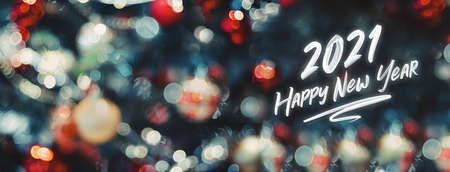 2021 happy new year word on abstract bokeh of  ball and string lights on xmas tree.holiday celebration greeting cardの写真素材