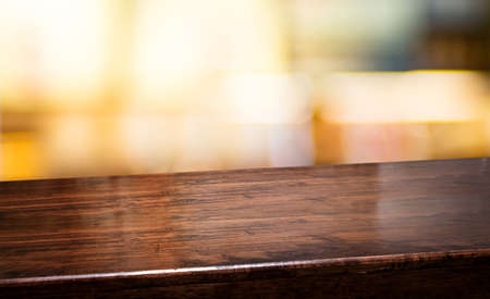 bar nightclub background.Empty diagonal brown wooden table with blur bar restaurant bokeh...