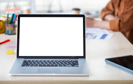 Mockup laptop blank screen on meeting table use to present project collaboration with colleagues.live streaming meetingの写真素材