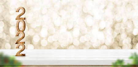 2022 happy new year wood number (3d rendering) on white wood table with sparkling gold bokeh wall...