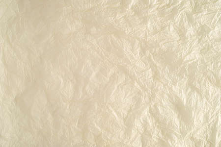 yellow pastel crumpled paper texture backgroundの写真素材