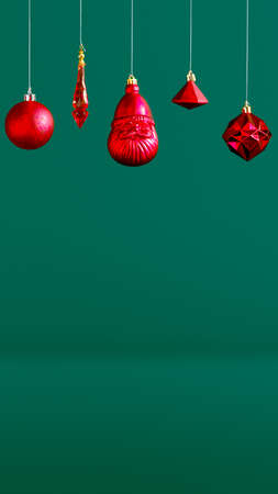 Christmas red bauble hanging decoration hanging on dark modern green background.winter holiday greeting cardの写真素材