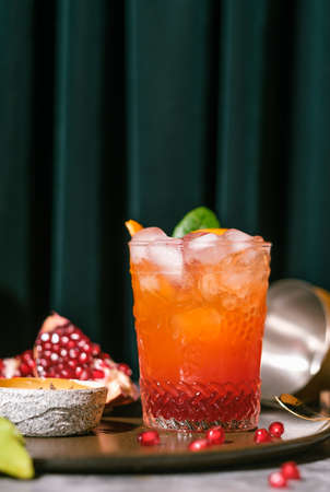 oragne juice mixed with pomegranate cocktail beverage drink on tableの写真素材