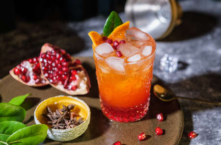 oragne juice mixed with pomegranate cocktail beverage drink on tableの写真素材