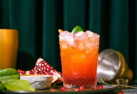 oragne juice mixed with pomegranate cocktail beverage drink on tableの写真素材