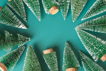 group of christmas tree lay on green backgorund top viewの写真素材