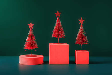 christmas tree red color with star pine tree group on green background with spaceの写真素材