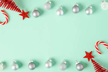 top view christmas ornament xmas tree,candy cane,bauble decor on pastel green backgroundの写真素材