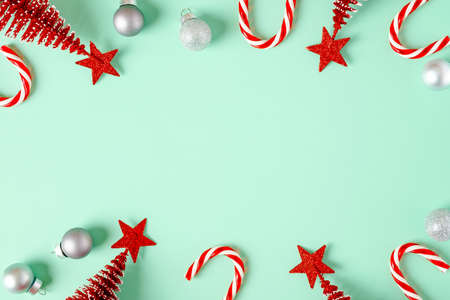 top view christmas ornament xmas tree,candy cane,bauble decor on pastel green backgroundの写真素材